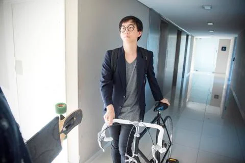 Man walking with bicycle in corridor Stock Photos
