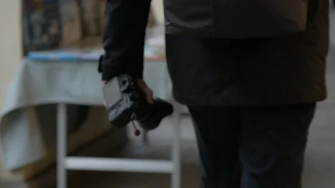 A man walking with a camera in his hand Stock Footage 120346795