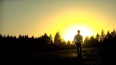 Man Walking to Camera at Sunset Stock Footage 84445112