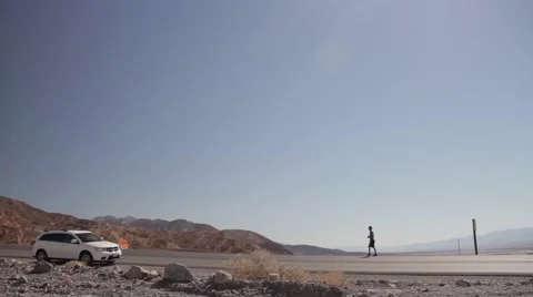 Man walking to car in desert 動画素材 56326478