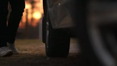 Man walking up to car wheels during sunset - 3 clip bundle 스톡 동영상 248695514