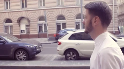 Man walking in the city side view medium shot. Urban scene with Handsome young Stock Footage 66456325