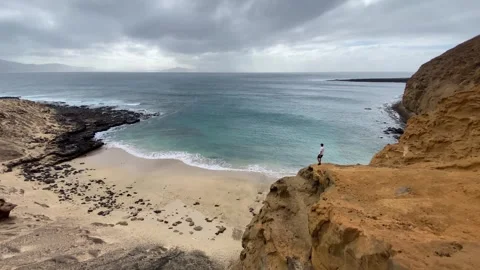 Man Walking On Cliff Above Ocean With Dramatic Clouds Timelapse 스톡 동영상 331268532