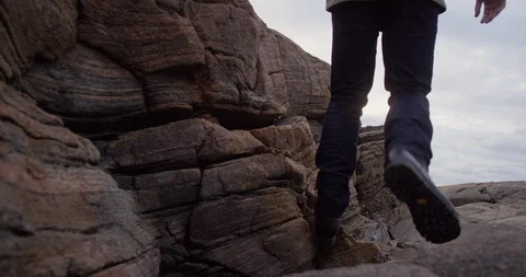 Man walking on cliffs by the sea. Stock Footage 106120077