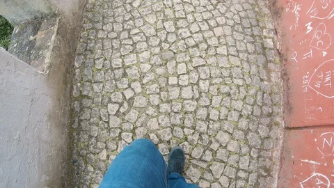 Man Walking On A Cobblestone Sidewalk In A Castle Stock Footage 114641133