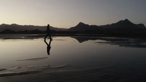 Man walking confidently at the sunset Reflection lake Stock Footage 121047320