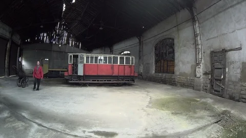 Man walking Dancing in an old train factory Stock Footage 104462910