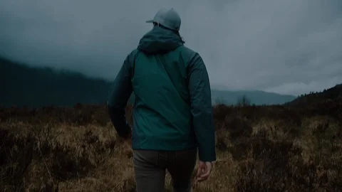 Man Walking in a Dark Misty Mountain Field Stock Footage 85743188