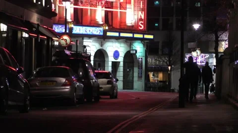Man walking on a dark street talking on his mobile phone Stock Footage 47037523