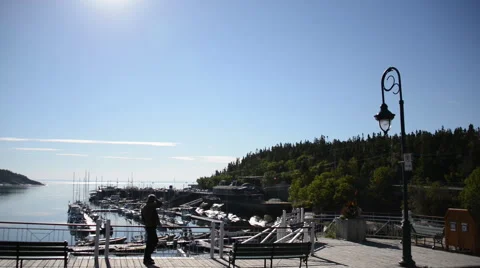 Man walking on a deck in front of a port Stock Footage 63868985