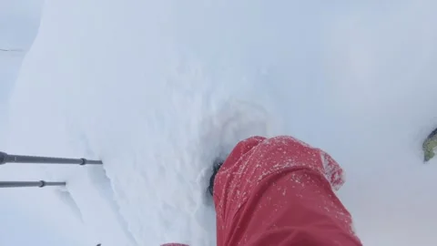 Man walking in the deep snow in the mountains in winter Stock Footage 132253473