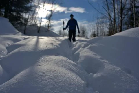 Man walking on deep snow out of focus Stock Photos