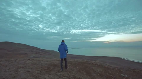 Man walking in desert at dawn Stock Footage 51452315