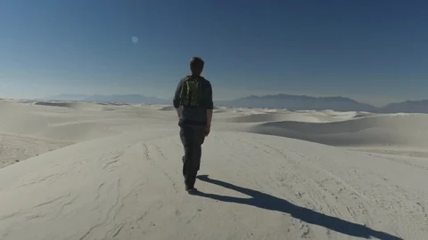Man walking on desert dunes Stock Footage 102293102