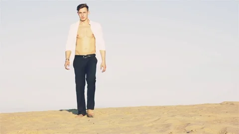 Man is walking in the desert Stock Footage 77210028