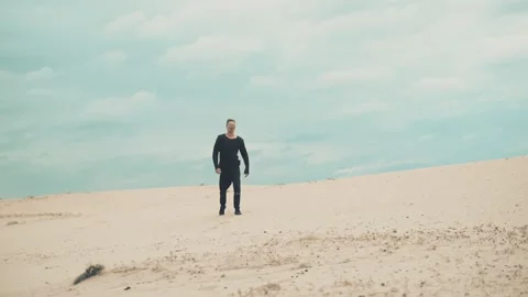 Man is walking in desert Stock Footage 89779602