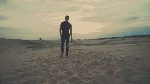 Man is walking in desert Stock Footage 102026671