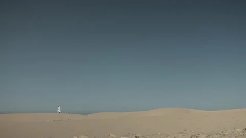 Man walking in the desert Stock Footage 167218957