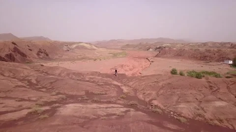 A man walking in the desert in Gansu province, China Stock Footage 312423448