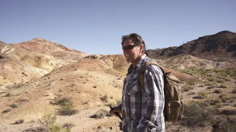 A man is walking in deserts are between rocks. Stock Footage 252793314