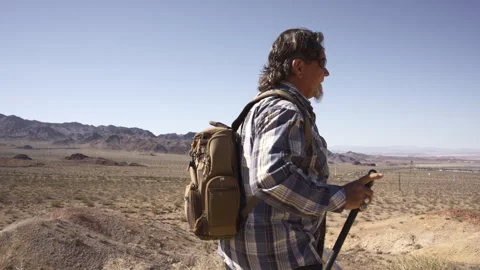 A man is walking in deserts are between rocks. Stock Footage 252794980