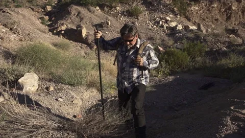 A man is walking in deserts are between rocks. Stock Footage 252853045