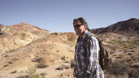 A man is walking in deserts are between rocks. Stock Footage 252858385