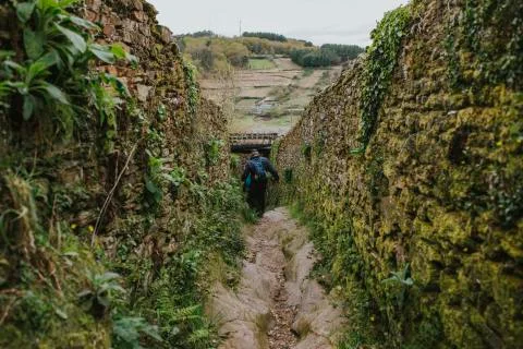 Man walking by a difficult path during a trekking journey Stock Photos