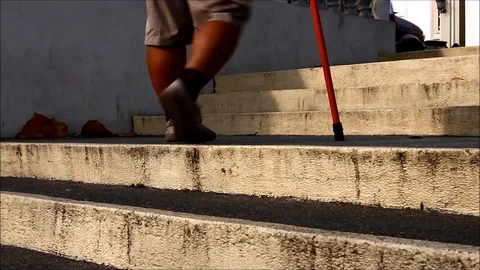 A man with walking disability walks with a cane Stock Footage 111299074