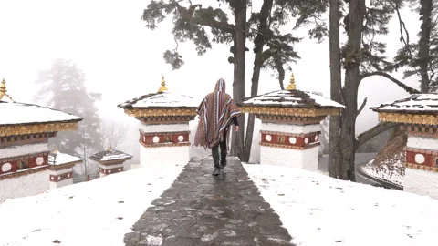 A man walking at the Dochula Pass, Druk Wangyal Chortens in Bhutan Stock Footage 220457027