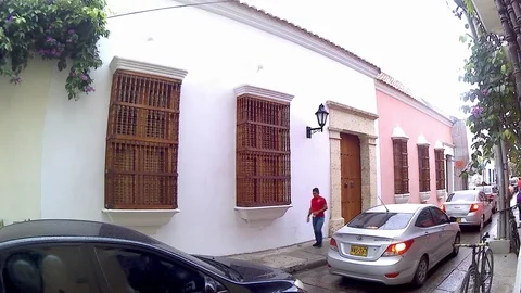 A man walking down a colonial street Stockbeeldmateriaal 89850949