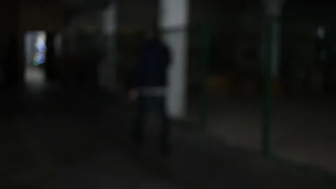 A man walking down a dark corridor. Stock Footage 169183817