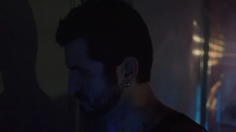 Man Walking Down a Dark Hallway Stock Footage 78826534