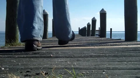 Man walking down a dock Video stock 44182704