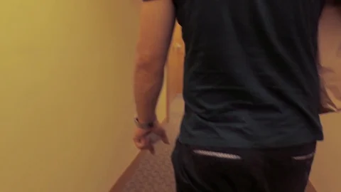 Man walking down the hall in hotel, opening room Stock Footage 90231881
