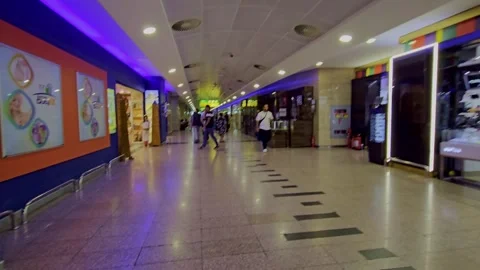 A man walking down a long hallway in a mall Stock-Footage 291951892