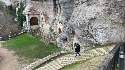 Man walking down the path to San Bernabé Hermitage in Ojo Guareña 動画素材 327864292