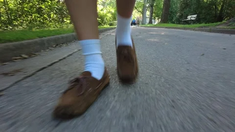 Man Walking Down Pathway As Other People Jog And Walk In Distance Extreme Cl Stock Footage 251879439