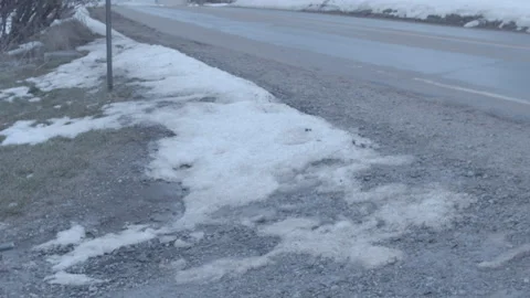 Man walking down road with snow Stock Footage 147773082