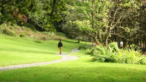 Man walking down a rural road on his vacations, serenity, outdoor activity 스톡 동영상 45071858