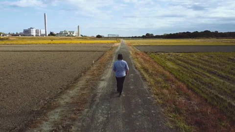 Man walking down rural road in rural Japan 库存影片 246462944