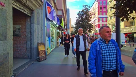 A man walking down a sidewalk with a bunch of people Stock Footage 273009616