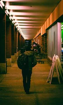 A man walking down the sidewalk in front of a shopping plaza in Chardon, Ohio Stock Photos