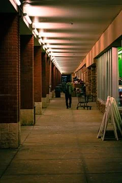 A man walking down the sidewalk in front of a shopping plaza in Chardon, Ohio Stock Photos