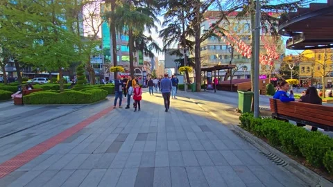 A man walking down a sidewalk with a skateboard Stock Footage 273009626