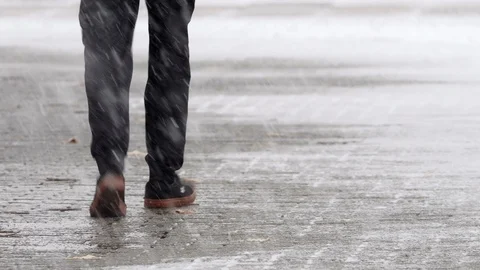 Man walking down the sidewalk in winter Stock Footage 120781612