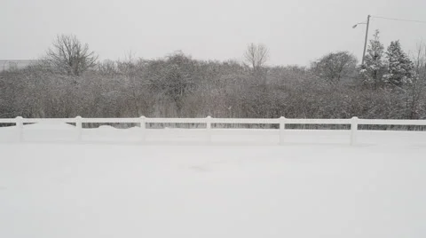 Man Walking Down snowy path during blizzard Stock Footage 49163579
