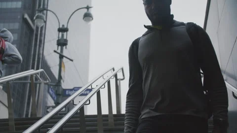 Man walking down stairs in New York while checking his phone in the daytime Stock Footage 312591215