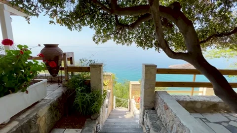 Man walking down stairs on restaurant terrace on the shores of the Sea Stock Footage 203818037