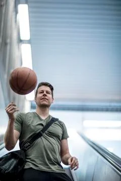 Man Walking Down a Stairwell With a Basketball Stock Photos